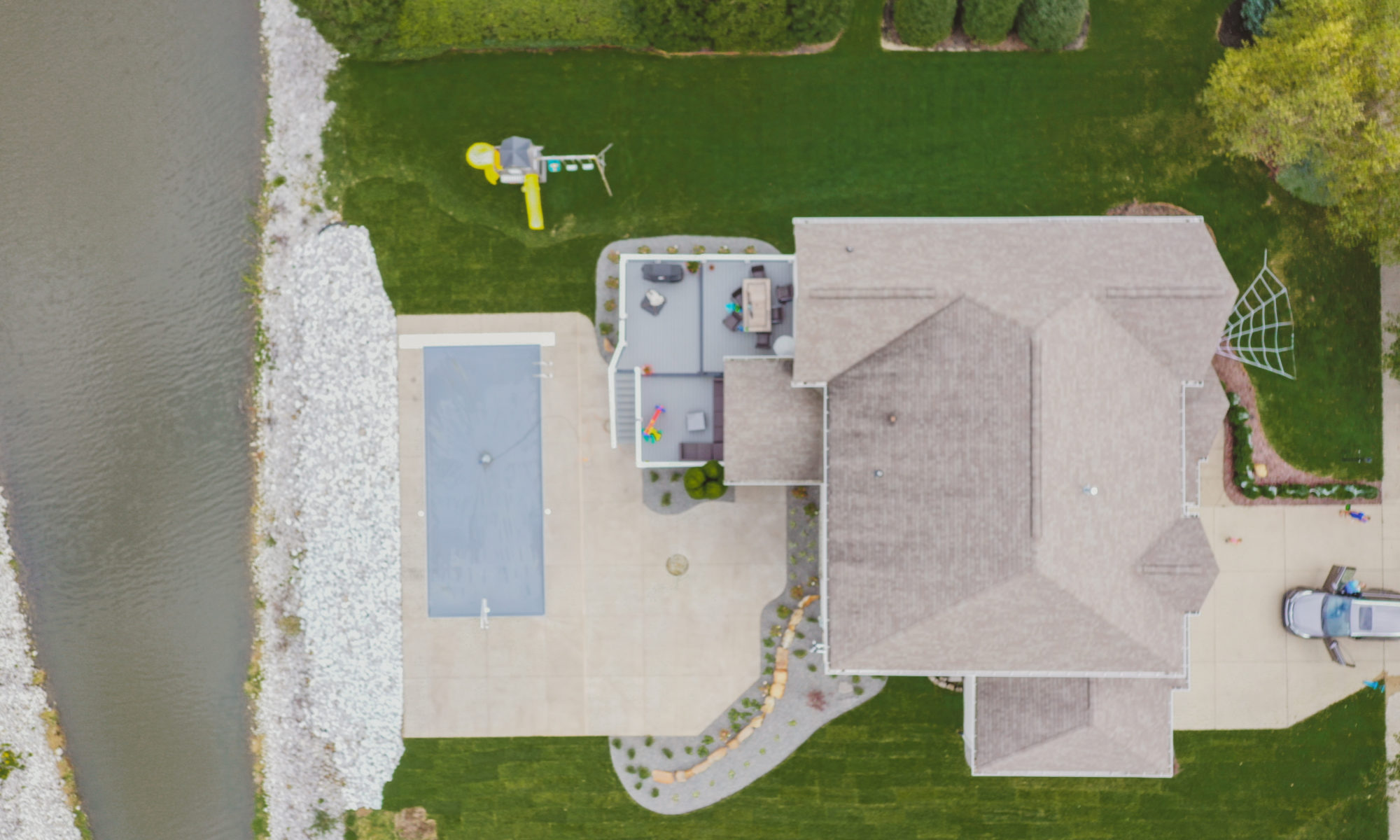 Precision Outdoors Poolside Landscaping Project Custom landscaping plants shrubs small boulders indianapolis Indiana dream backyard