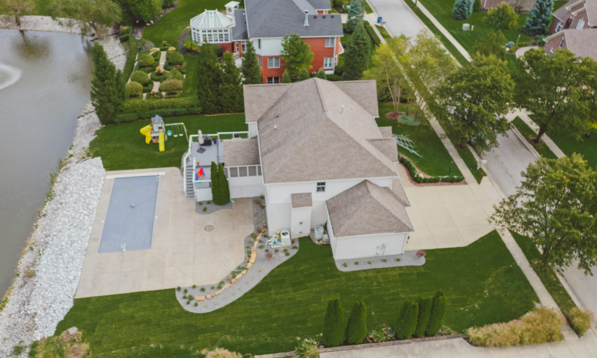Precision Outdoors Poolside Landscaping Project Custom landscaping plants shrubs small boulders indianapolis Indiana dream backyard