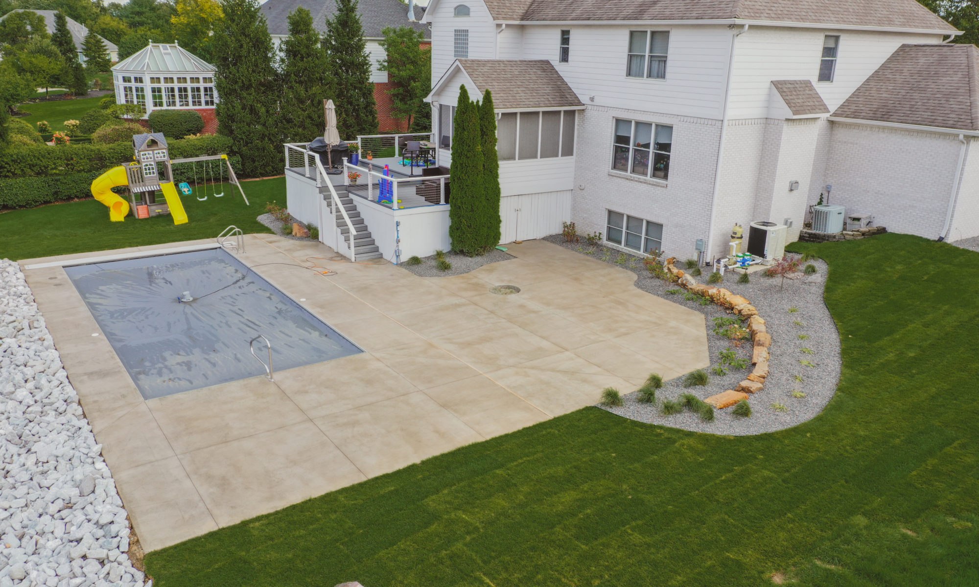 Precision Outdoors Poolside Landscaping Project Custom landscaping plants shrubs small boulders indianapolis Indiana dream backyard