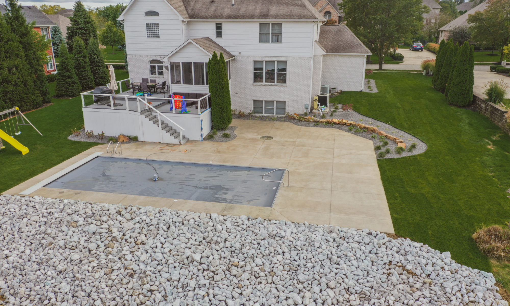 Precision Outdoors Poolside Landscaping Project Custom landscaping plants shrubs small boulders indianapolis Indiana dream backyard