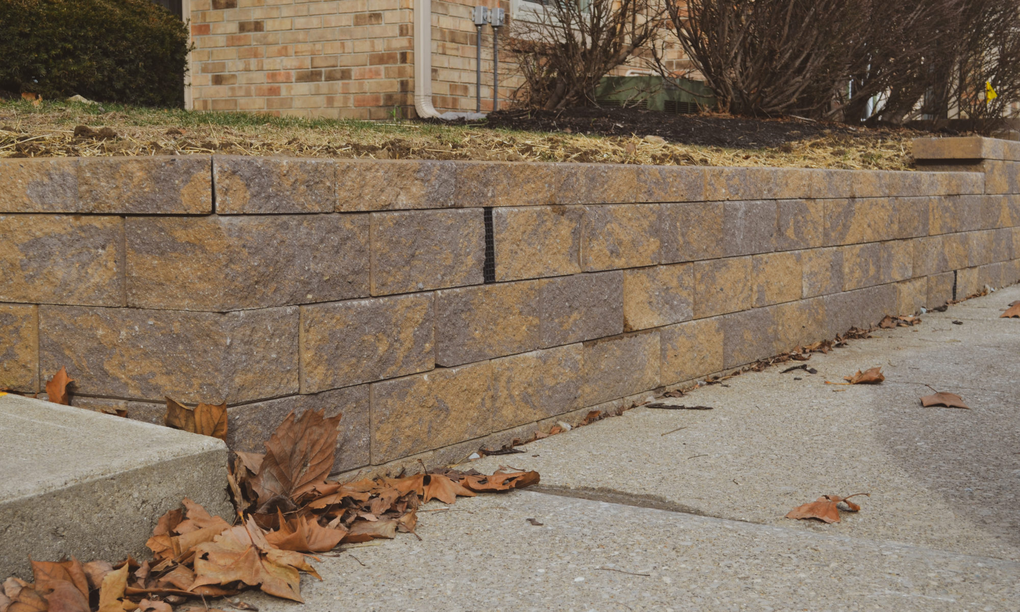 Precision Outdoors Mission Hills Apartments Gable Roof Structure Linear gas firepit paver patio seating wall Carmel indiana curb appeal