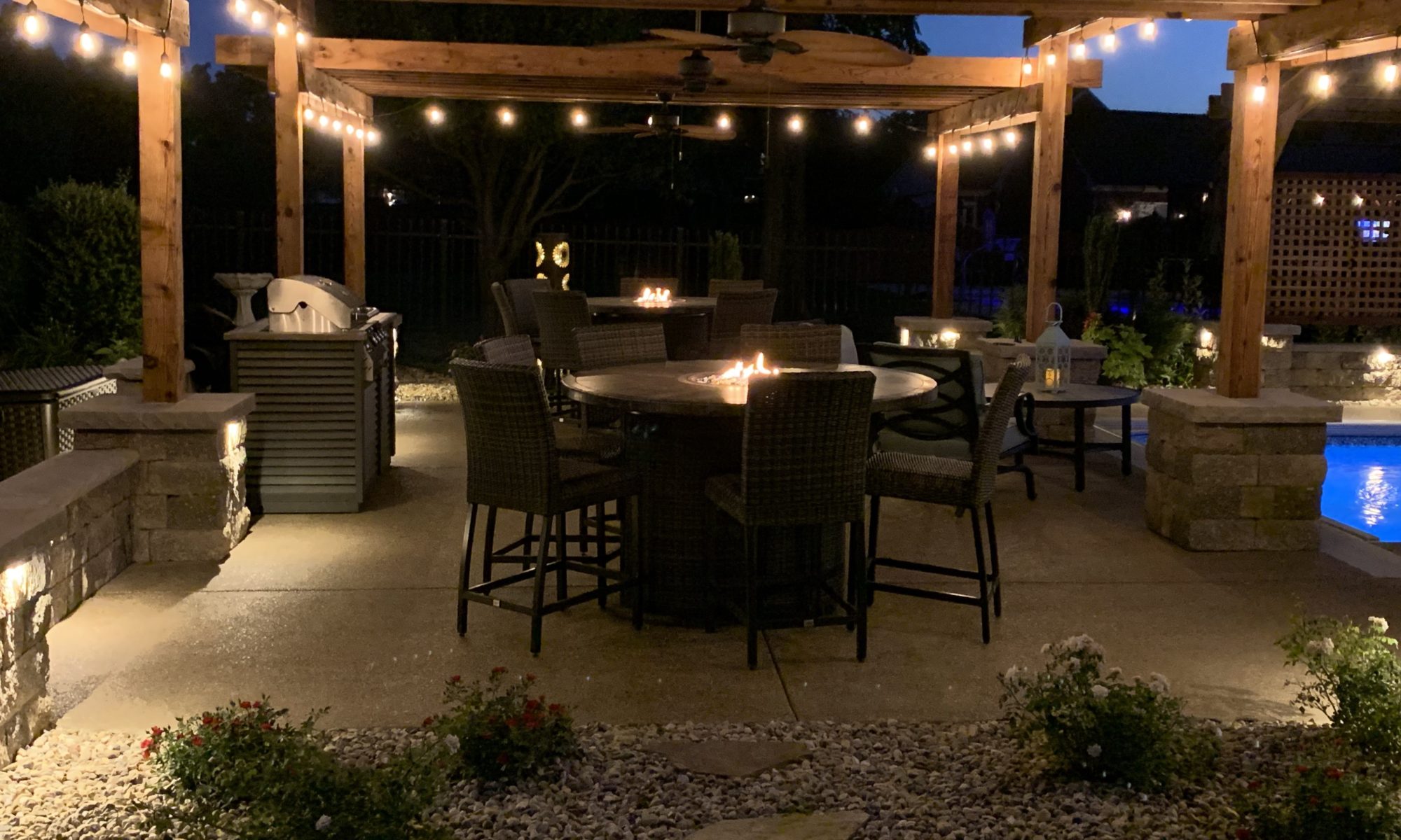 Precision Outdoors cannon cabana nights completed project night night time pool life fire table fire pit pool deck pergola outdoor kitchen timber structures retaining wall sun screens privacy screens outdoor dining entertaining space Greenwood Indiana