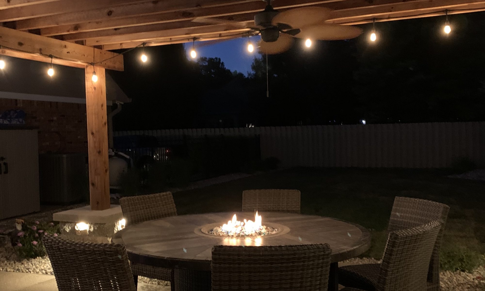 Precision Outdoors cannon cabana nights completed project night night time pool life fire table fire pit pool deck pergola outdoor kitchen timber structures retaining wall sun screens privacy screens outdoor dining entertaining space Greenwood Indiana
