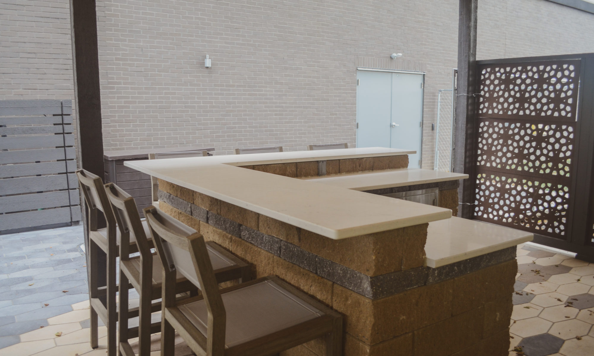 Precision outdoors sophisticated commercial property paver patio modern step walkway cable railing large outdoor dining space outdoor kitchen sink grill miniature refrigerator mini fridge extra seating bar decorative sunscreen sunscreens indianapolis indiana