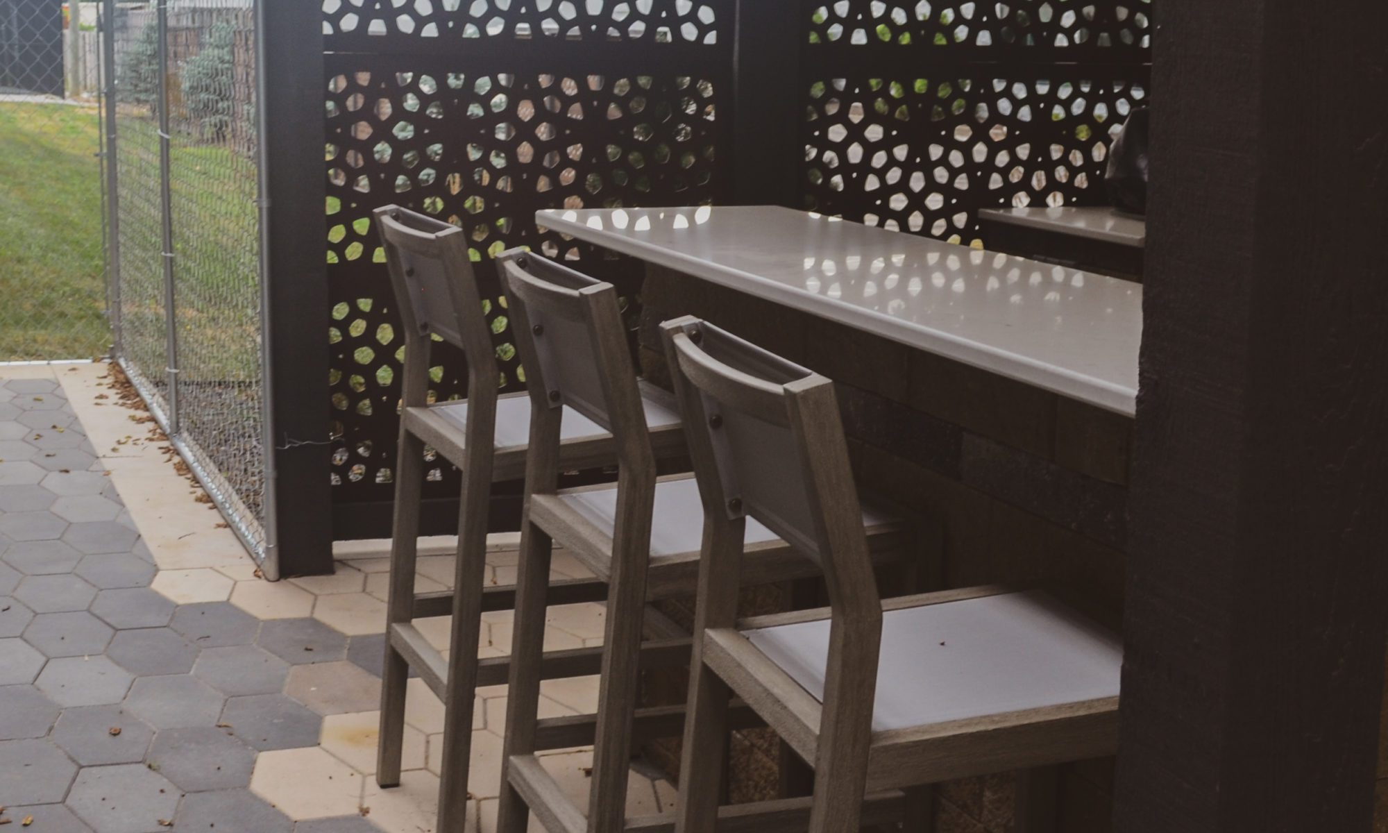Precision outdoors sophisticated commercial property paver patio modern step walkway cable railing large outdoor dining space outdoor kitchen sink grill miniature refrigerator mini fridge extra seating bar decorative sunscreen sunscreens indianapolis indiana