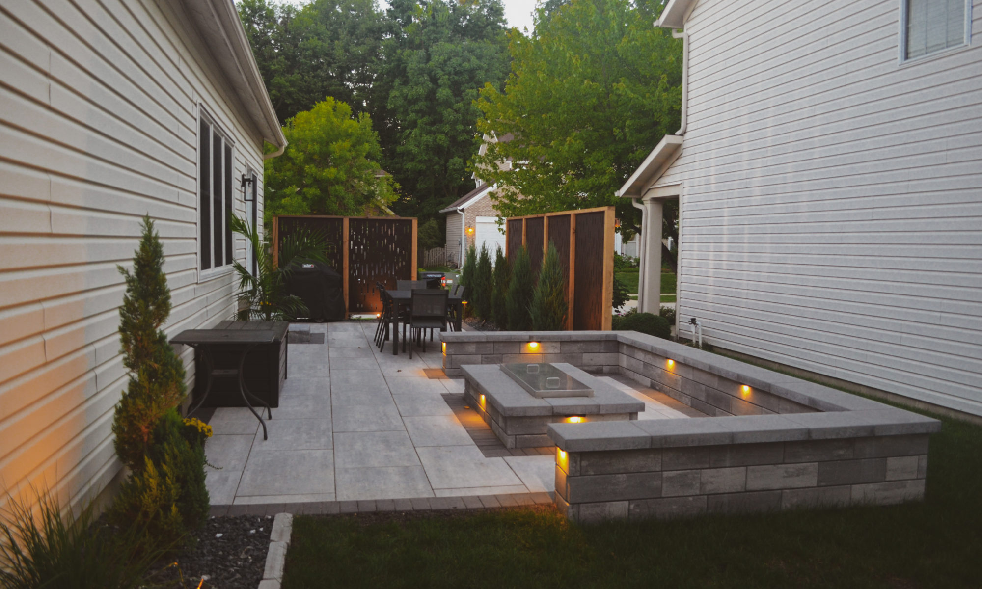 The Private Plaza privacy screens custom landscaping fire pit arborvitae private dining privacy Carmel indiana landscaping walkway Night Lighting