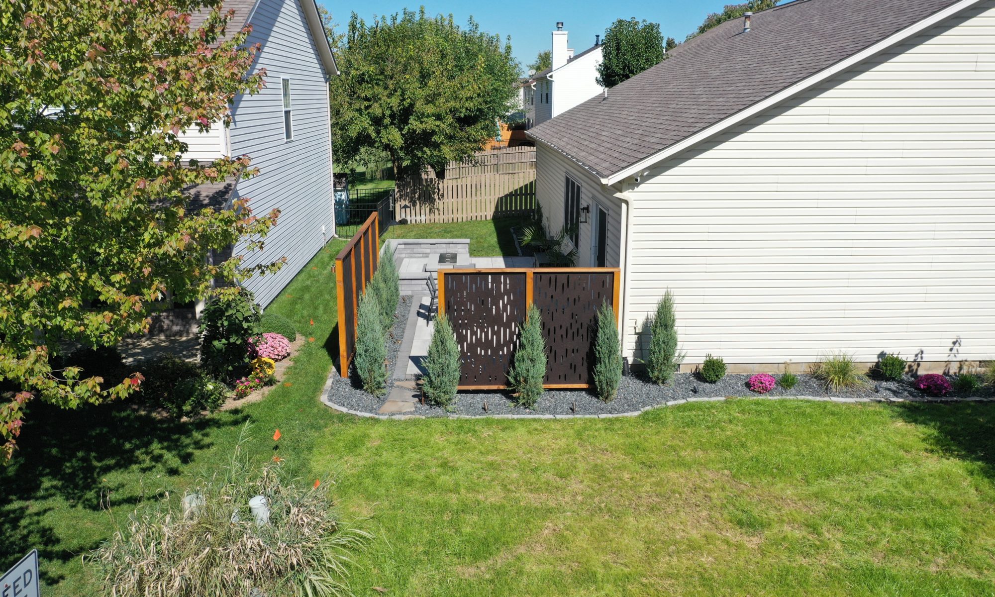 The Private Plaza privacy screens custom landscaping fire pit arborvitae private dining privacy Carmel indiana landscaping walkway