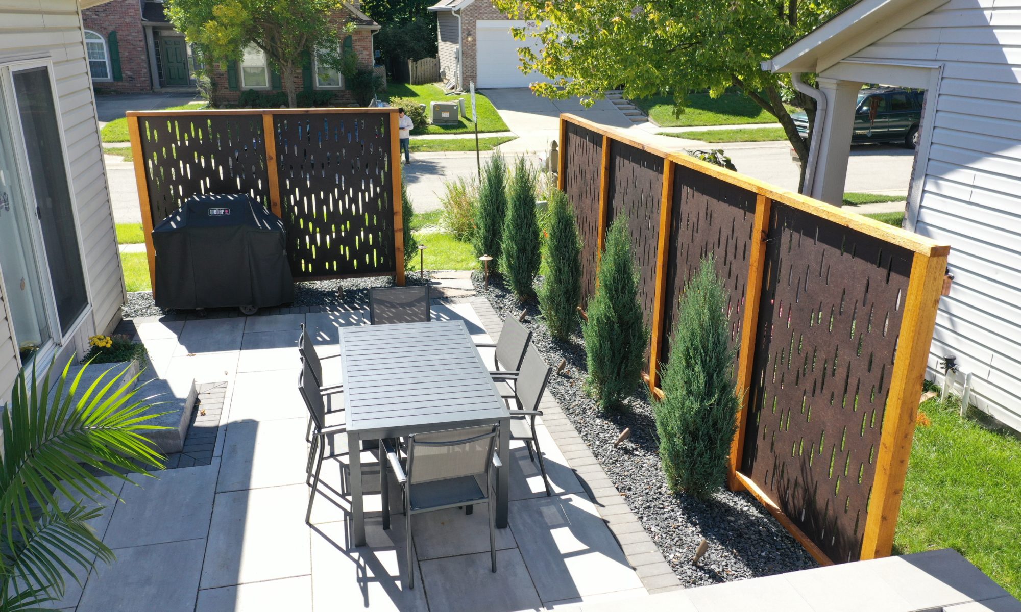 The Private Plaza privacy screens custom landscaping fire pit arborvitae private dining privacy Carmel indiana landscaping walkway