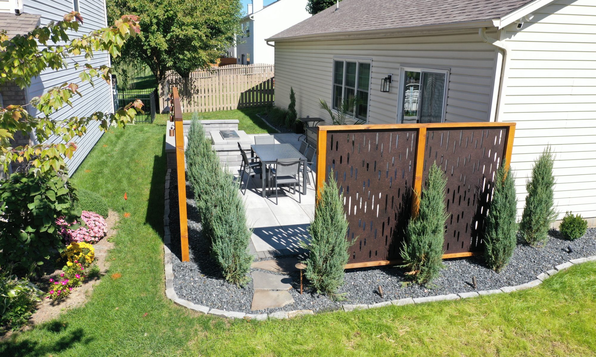 The Private Plaza privacy screens custom landscaping fire pit arborvitae private dining privacy Carmel indiana landscaping walkway