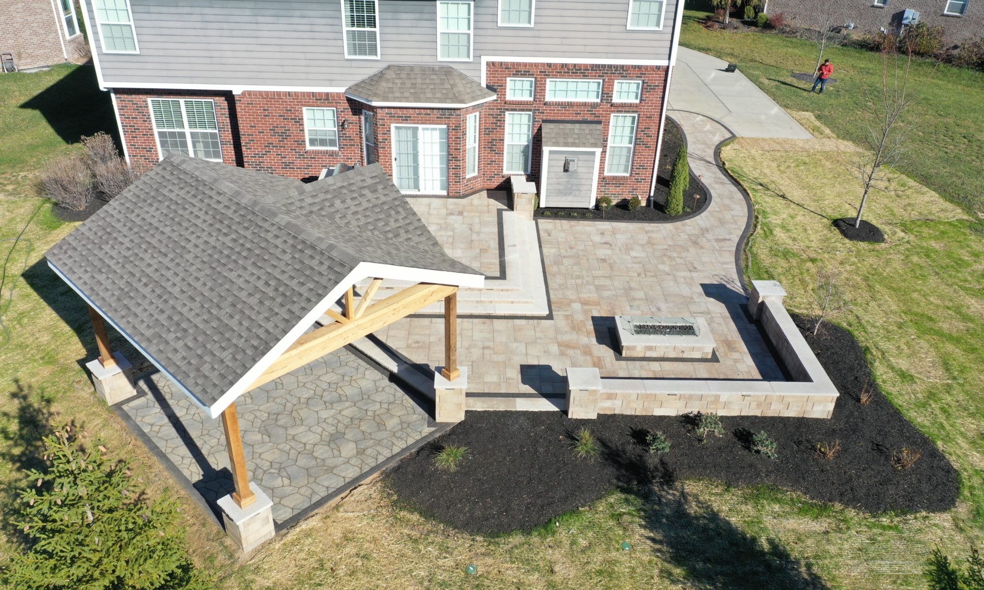 Gables at Hickory Stick Greenwood Bargersville Indiana Paver Patio Gas burning fire pit exterior build dream backyard gable roof structure walkway custom custom landscaping outdoor kitchen mini fridge mini refrigerator fan lighting grill