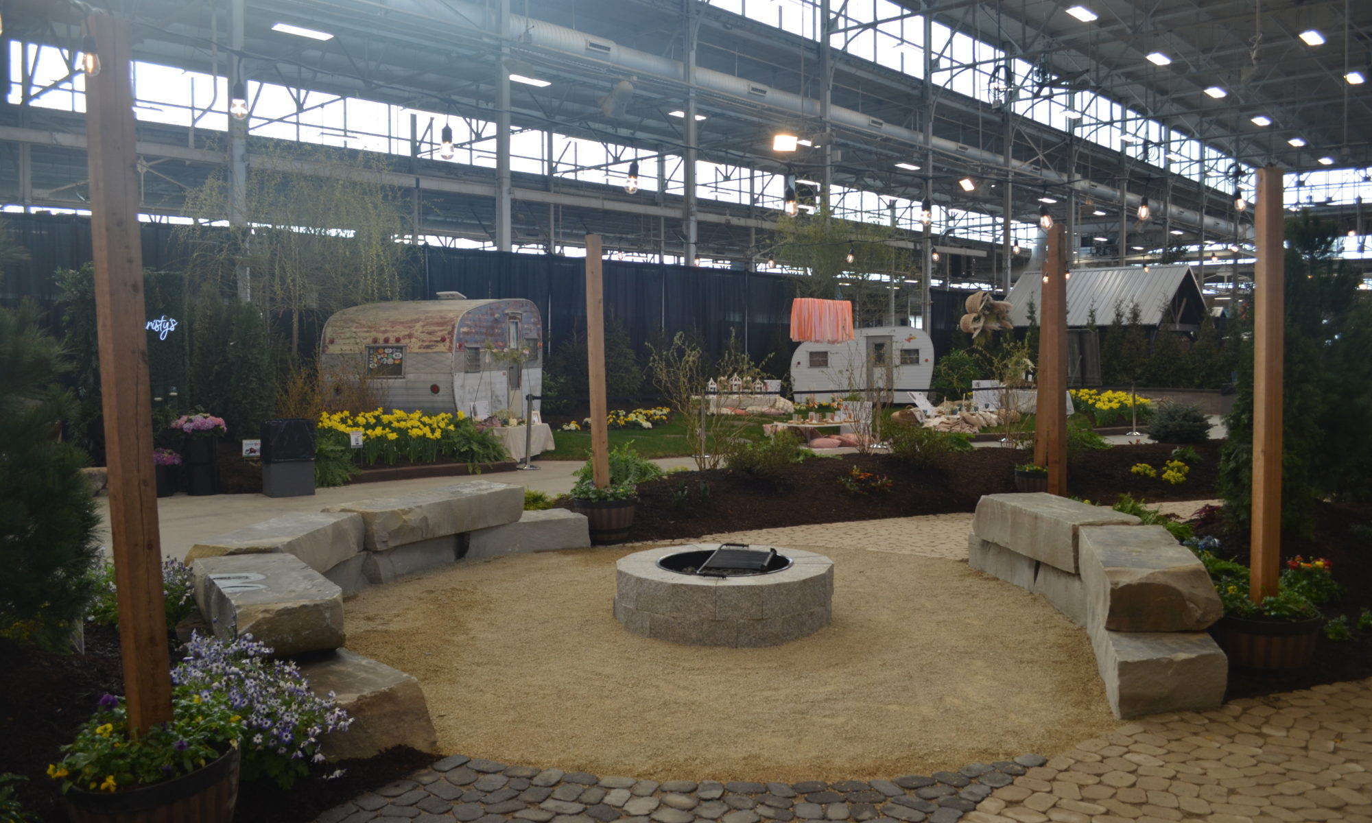 indiana indianapolis flower and patio show 2022 pergola fire pit swing swings lighting landscaping custom bubbling boulder water feature fire pit modern pergola outdoor grill island arbors custom swings landscaping precision outdoors