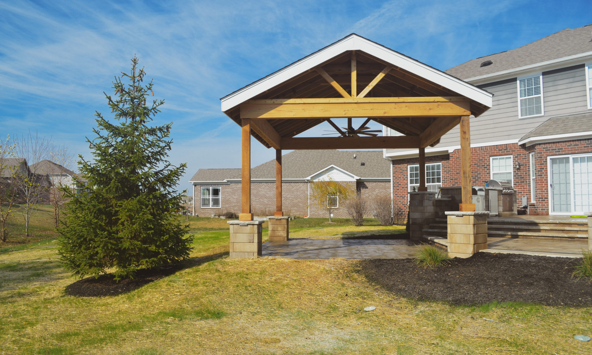 Gables at Hickory Stick Greenwood Bargersville Indiana Paver Patio Gas burning fire pit exterior build dream backyard gable roof structure walkway custom custom landscaping outdoor kitchen mini fridge mini refrigerator fan lighting grill