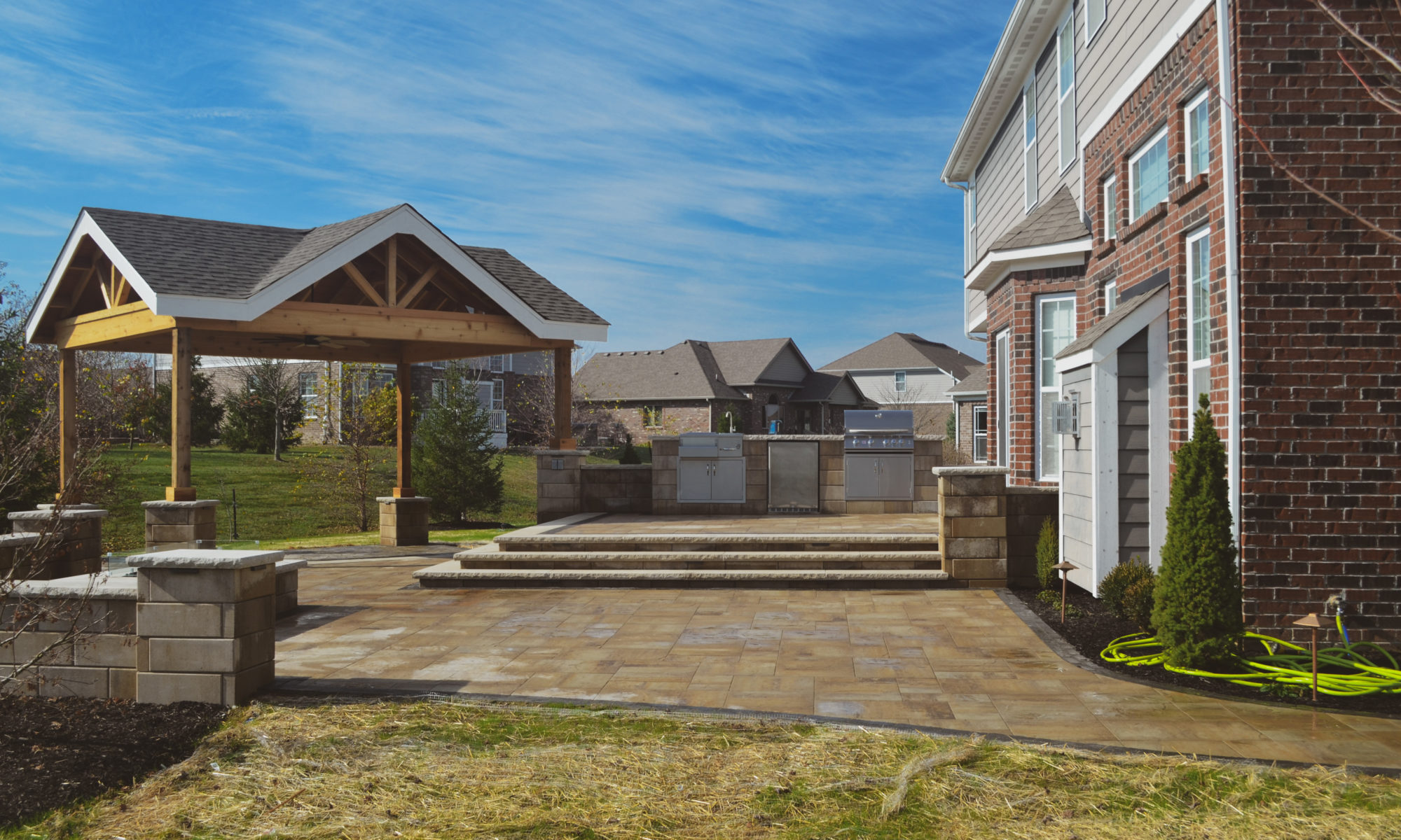 Gables at Hickory Stick Greenwood Bargersville Indiana Paver Patio Gas burning fire pit exterior build dream backyard gable roof structure walkway custom custom landscaping outdoor kitchen mini fridge mini refrigerator fan lighting grill