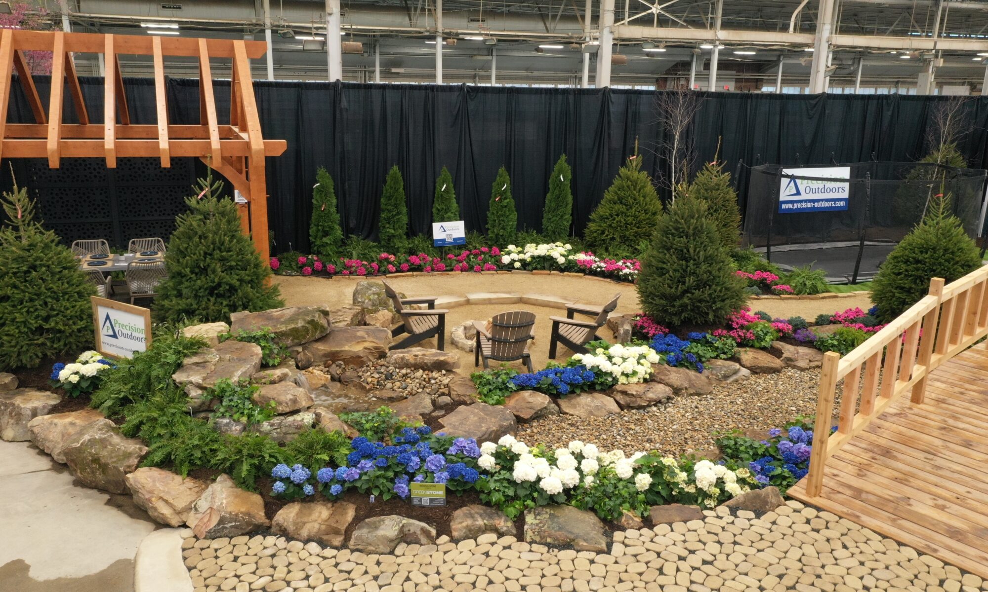 Precision Outdoors Flower and patio show 2023 indianapolis exterior build backyard goals dream backyard the smart pergola belgard plants shrubs tree water features bridge rock pavers paver fire pit lawn games connect four giant jingo astroturf astro turf traditional pergola modern pergola honeycomb tile checkers corn hole precision stone walkway inground in ground trampoline wooden playhouse woodman playhouses custom outdoor pitching dining cedar fountain beautiful display boulders boulder private privacy screen screens cozy entertainment entertaining precision design services