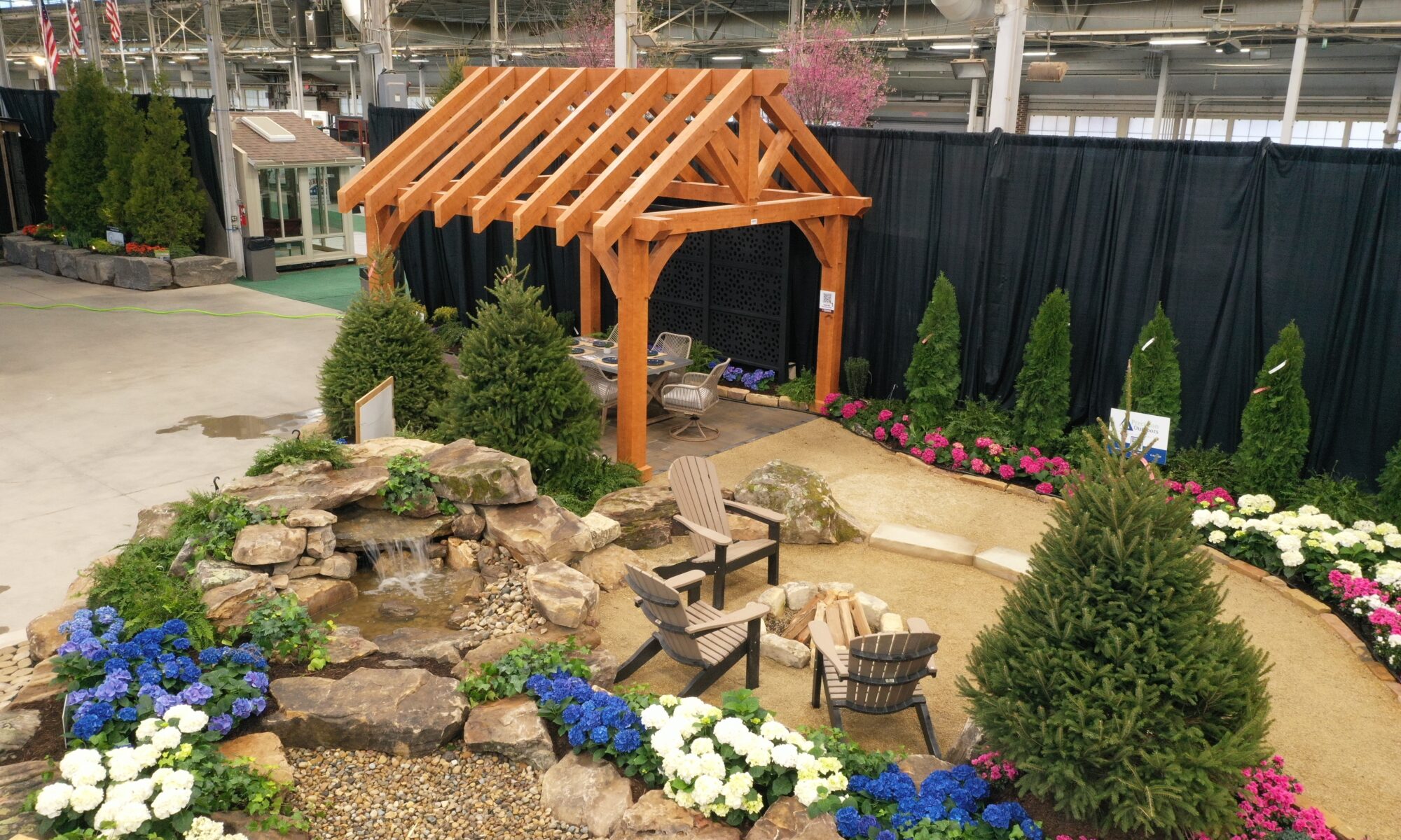 Precision Outdoors Flower and patio show 2023 indianapolis exterior build backyard goals dream backyard the smart pergola belgard plants shrubs tree water features bridge rock pavers paver fire pit lawn games connect four giant jingo astroturf astro turf traditional pergola modern pergola honeycomb tile checkers corn hole precision stone walkway inground in ground trampoline wooden playhouse woodman playhouses custom outdoor pitching dining cedar fountain beautiful display boulders boulder private privacy screen screens cozy entertainment entertaining precision design services