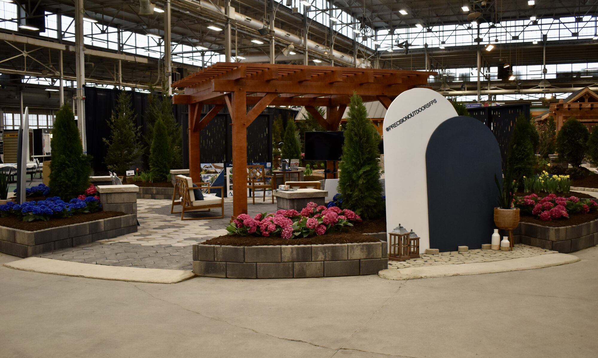 Precision Outdoors Flower and patio show 2023 indianapolis exterior build backyard goals dream backyard the smart pergola belgard plants shrubs tree water features bridge rock pavers paver fire pit lawn games connect four giant jingo astroturf astro turf traditional pergola modern pergola honeycomb tile checkers corn hole precision stone walkway inground in ground trampoline wooden playhouse woodman playhouses custom outdoor pitching dining cedar fountain beautiful display boulders boulder private privacy screen screens cozy entertainment entertaining precision design services