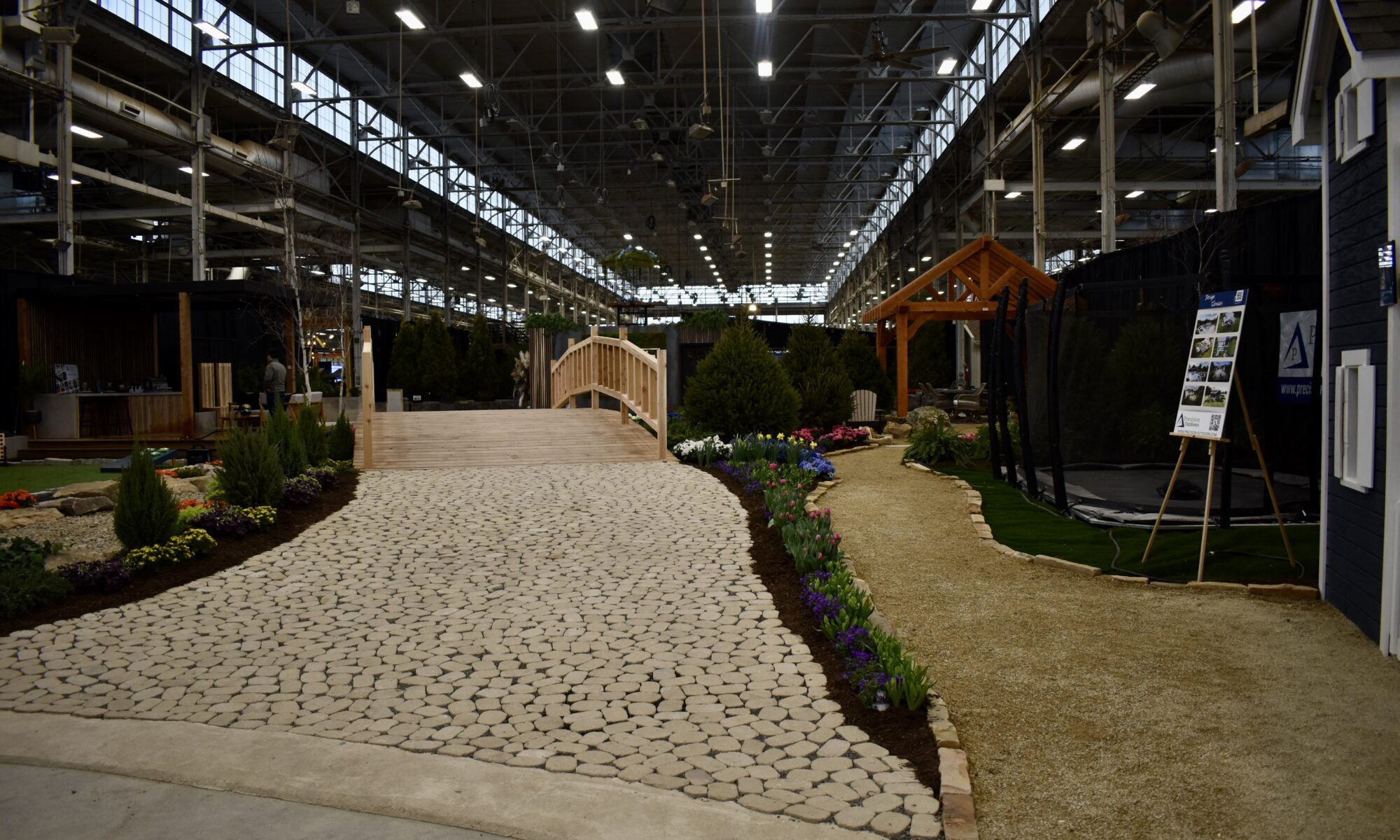 Precision Outdoors Flower and patio show 2023 indianapolis exterior build backyard goals dream backyard the smart pergola belgard plants shrubs tree water features bridge rock pavers paver fire pit lawn games connect four giant jingo astroturf astro turf traditional pergola modern pergola honeycomb tile checkers corn hole precision stone walkway inground in ground trampoline wooden playhouse woodman playhouses custom outdoor pitching dining cedar fountain beautiful display boulders boulder private privacy screen screens cozy entertainment entertaining precision design services