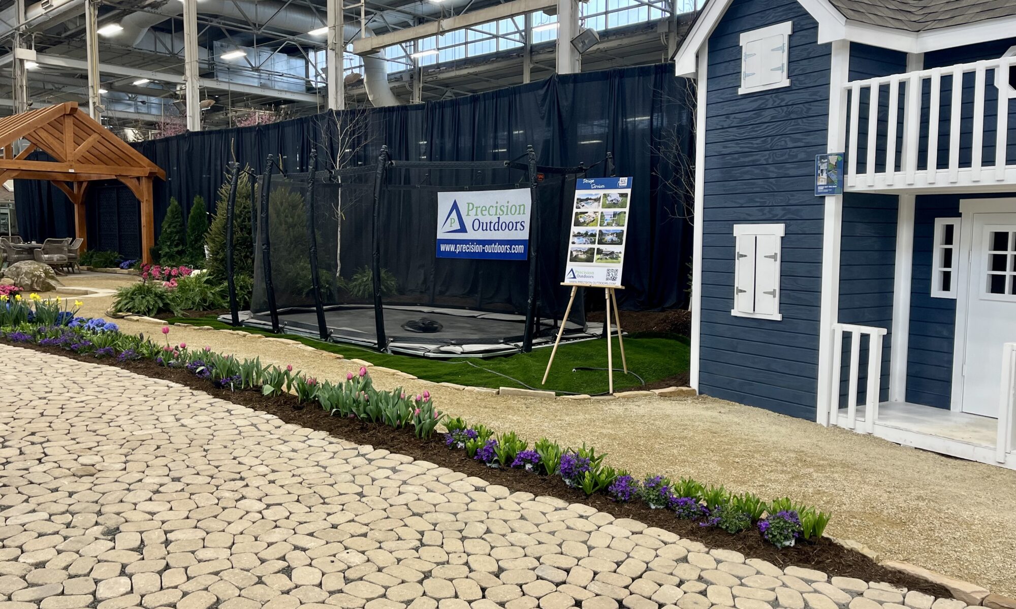 Precision Outdoors Flower and patio show 2023 indianapolis exterior build backyard goals dream backyard the smart pergola belgard plants shrubs tree water features bridge rock pavers paver fire pit lawn games connect four giant jingo astroturf astro turf traditional pergola modern pergola honeycomb tile checkers corn hole precision stone walkway inground in ground trampoline wooden playhouse woodman playhouses custom outdoor pitching dining cedar fountain beautiful display boulders boulder private privacy screen screens cozy entertainment entertaining precision design services