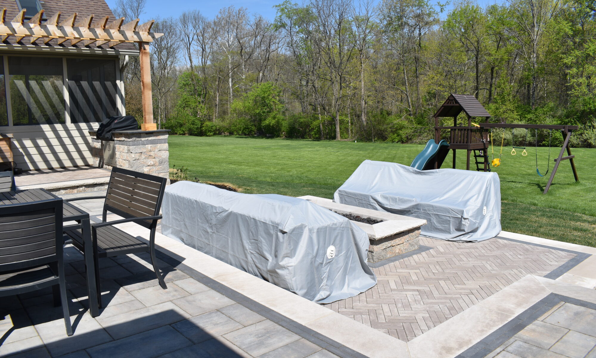 Precision Outdoors Terrace at Fox Run Zionsville Indiana Exterior design and build unilock estate wall river beacon hill flagstone alpine grey fossil unilock mattoni dark charcoal sable brown pergola outdoor kitchen gas fire pit outdoor dining area grill space several entertaining spaces large paver patio multilevel patio custom landscaping sod backyard goals mulch tree plants outdoor lighting