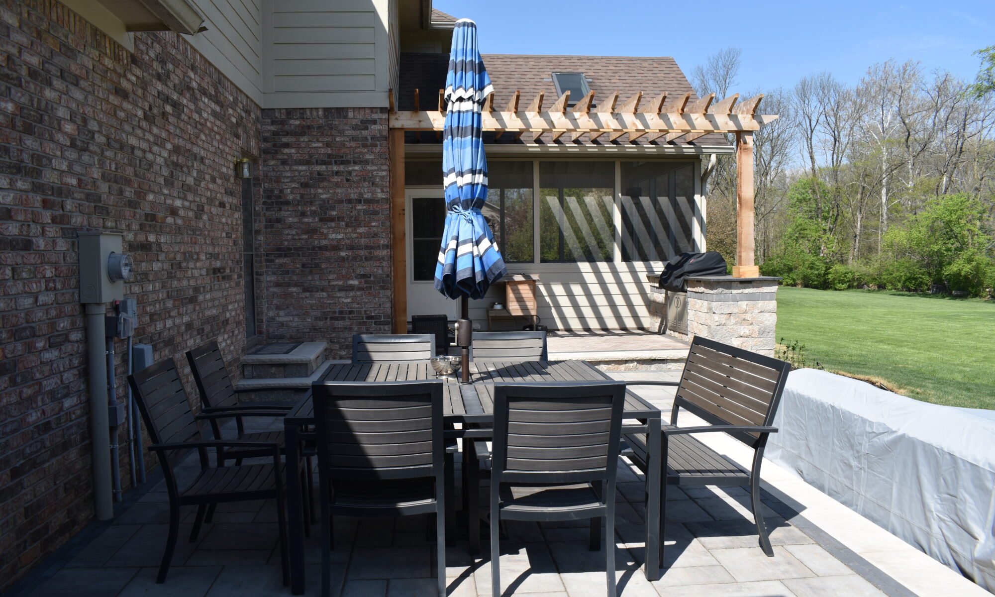 Precision Outdoors Terrace at Fox Run Zionsville Indiana Exterior design and build unilock estate wall river beacon hill flagstone alpine grey fossil unilock mattoni dark charcoal sable brown pergola outdoor kitchen gas fire pit outdoor dining area grill space several entertaining spaces large paver patio multilevel patio custom landscaping sod backyard goals mulch tree plants outdoor lighting