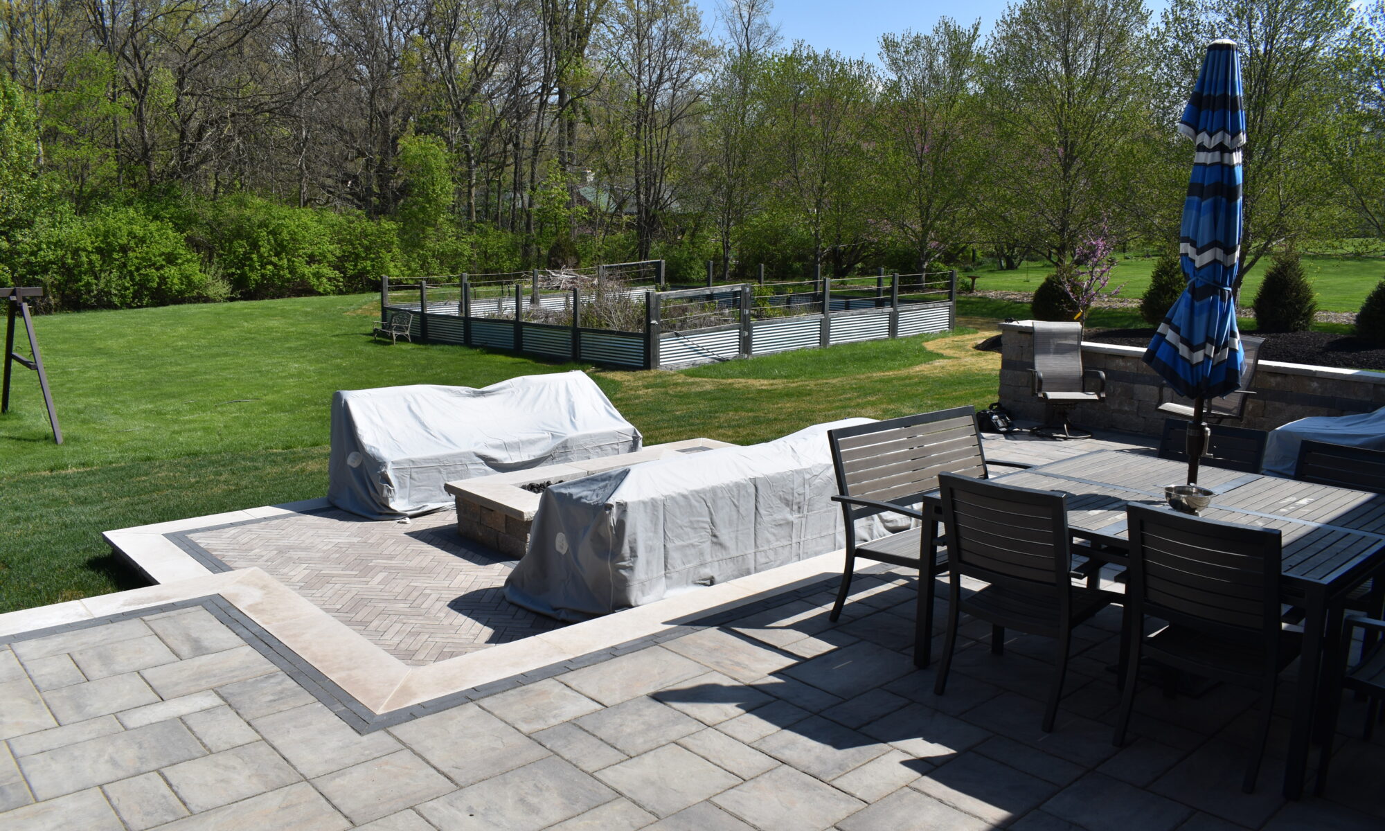 Precision Outdoors Terrace at Fox Run Zionsville Indiana Exterior design and build unilock estate wall river beacon hill flagstone alpine grey fossil unilock mattoni dark charcoal sable brown pergola outdoor kitchen gas fire pit outdoor dining area grill space several entertaining spaces large paver patio multilevel patio custom landscaping sod backyard goals mulch tree plants outdoor lighting