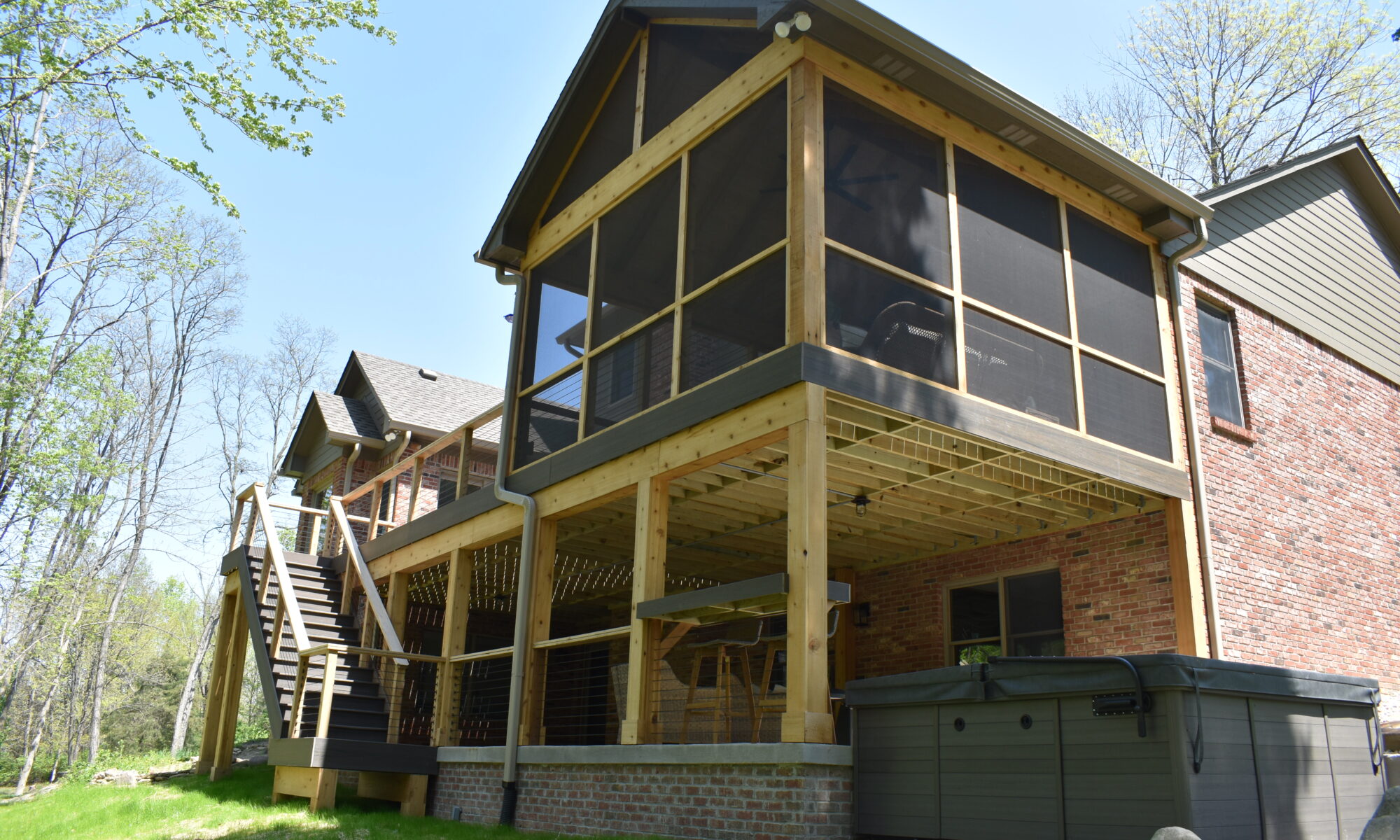precision outdoors Bargersville elevated Exterior backyard remodel Trex composite decking concrete patio hot tub backyard goals dream backyard screened in porch outdoor living space dining area indiana exterior design relaxing outdoors tongue and groove ceiling modern cable railing custom rock landscaping walkway