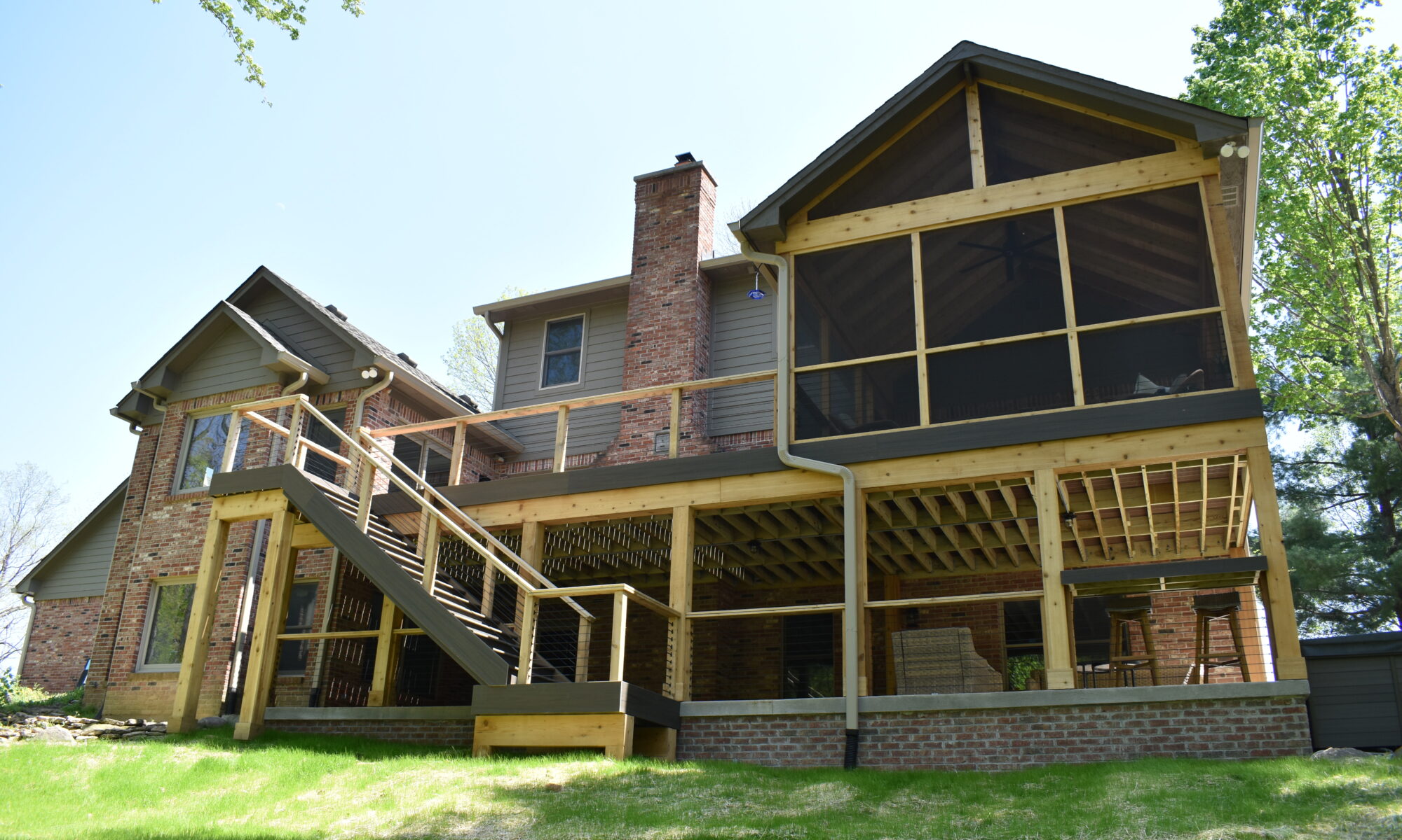 precision outdoors Bargersville elevated Exterior backyard remodel Trex composite decking concrete patio hot tub backyard goals dream backyard screened in porch outdoor living space dining area indiana exterior design relaxing outdoors tongue and groove ceiling modern cable railing custom rock landscaping walkway
