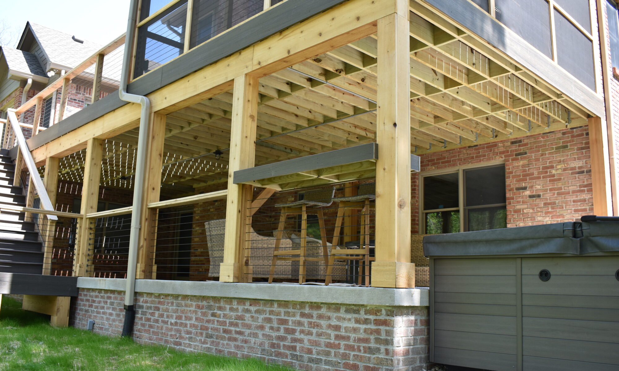 precision outdoors Bargersville elevated Exterior backyard remodel Trex composite decking concrete patio hot tub backyard goals dream backyard screened in porch outdoor living space dining area indiana exterior design relaxing outdoors tongue and groove ceiling modern cable railing custom rock landscaping walkway