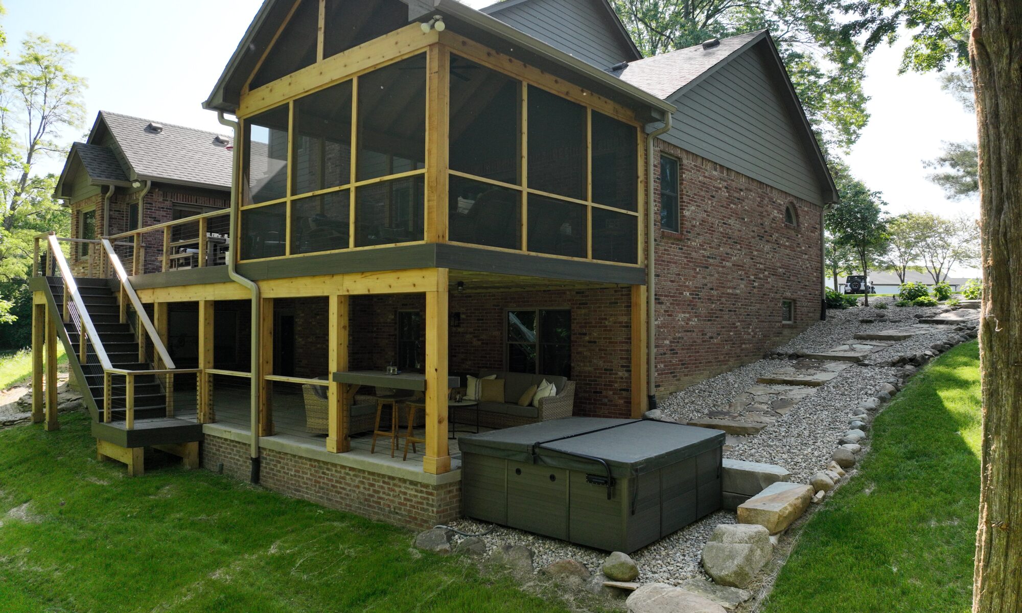 precision outdoors Bargersville elevated Exterior backyard remodel Trex composite decking concrete patio hot tub backyard goals dream backyard screened in porch outdoor living space dining area indiana exterior design relaxing outdoors tongue and groove ceiling modern cable railing custom rock landscaping walkway