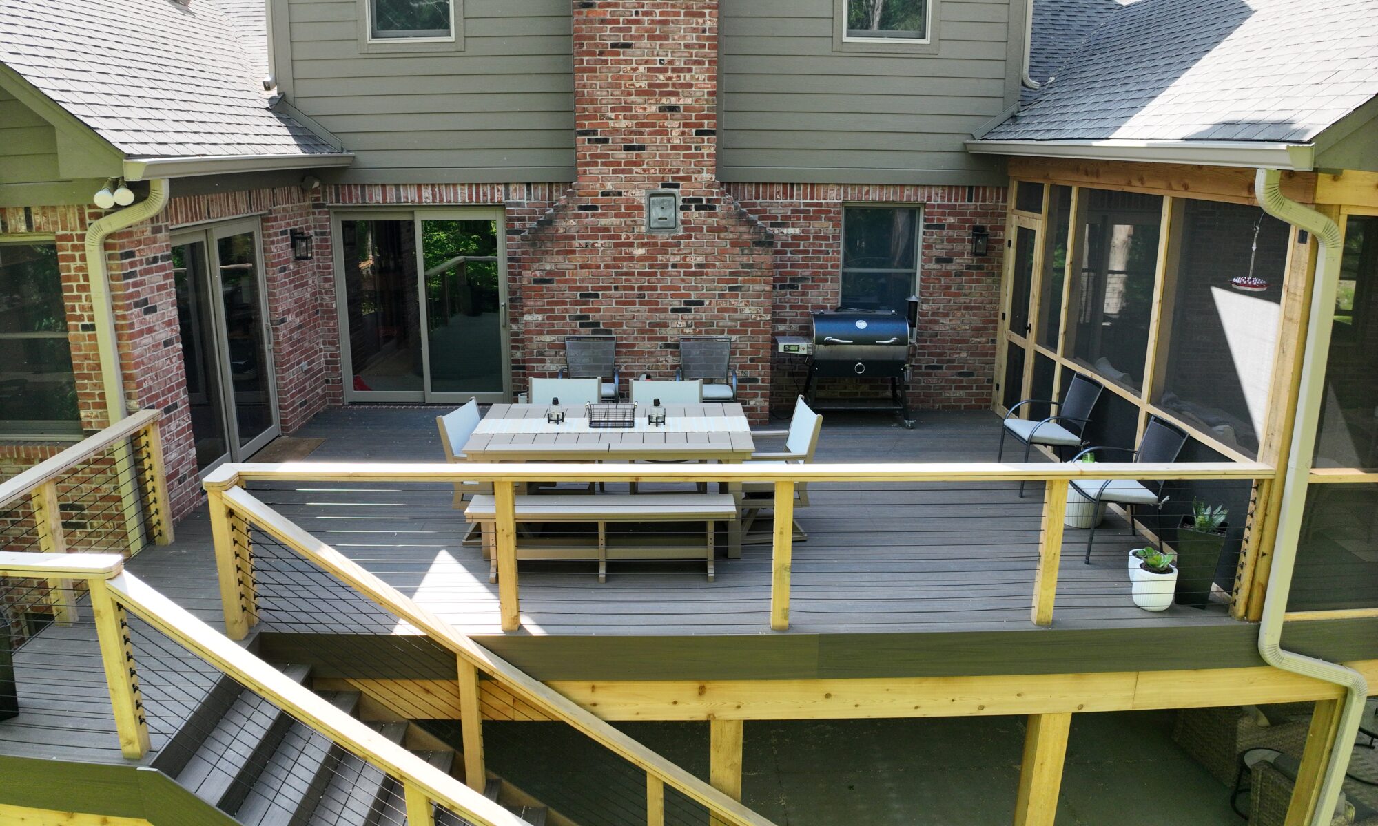 precision outdoors Bargersville elevated Exterior backyard remodel Trex composite decking concrete patio hot tub backyard goals dream backyard screened in porch outdoor living space dining area indiana exterior design relaxing outdoors tongue and groove ceiling modern cable railing custom rock landscaping walkway