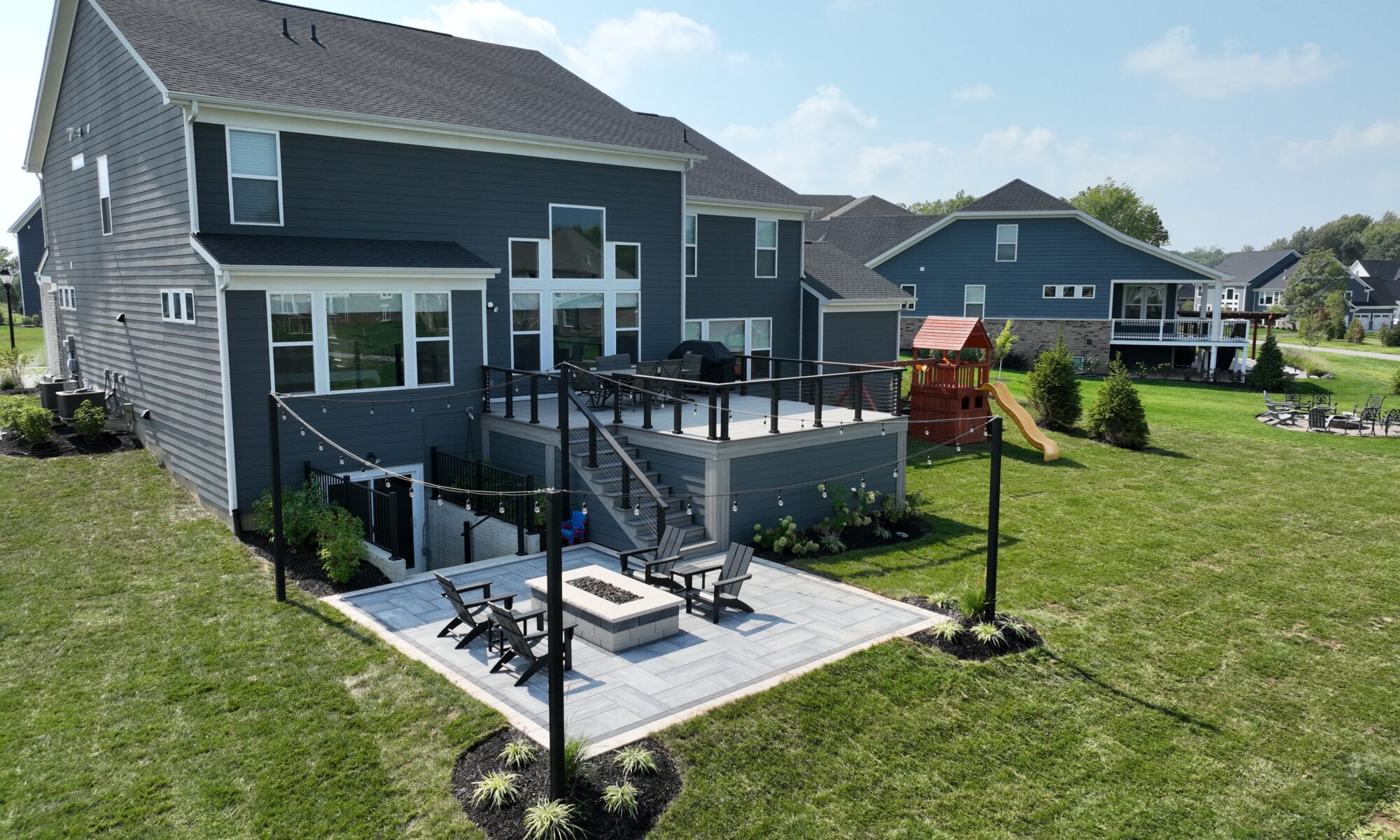 Chatham Elevated Deck Precision Outdoors Deckorators Decking Westfield Indiana Custom Cable railing composition deck string lighting gas firepit fire pit walk out basement custom landscaping paver patio beautiful backyard entertaining space relaxing space