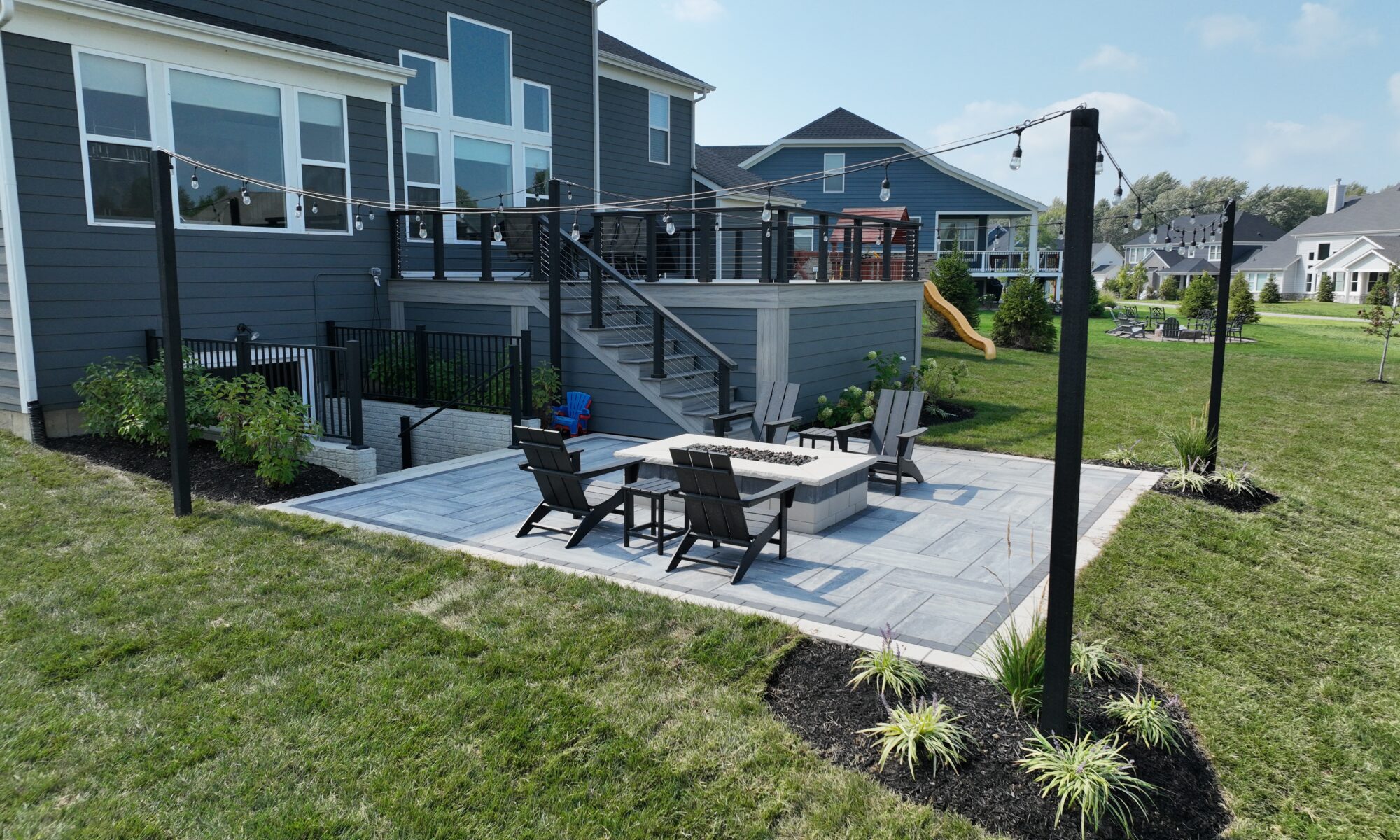 Chatham Elevated Deck Precision Outdoors Deckorators Decking Westfield Indiana Custom Cable railing composition deck string lighting gas firepit fire pit walk out basement custom landscaping paver patio beautiful backyard entertaining space relaxing space