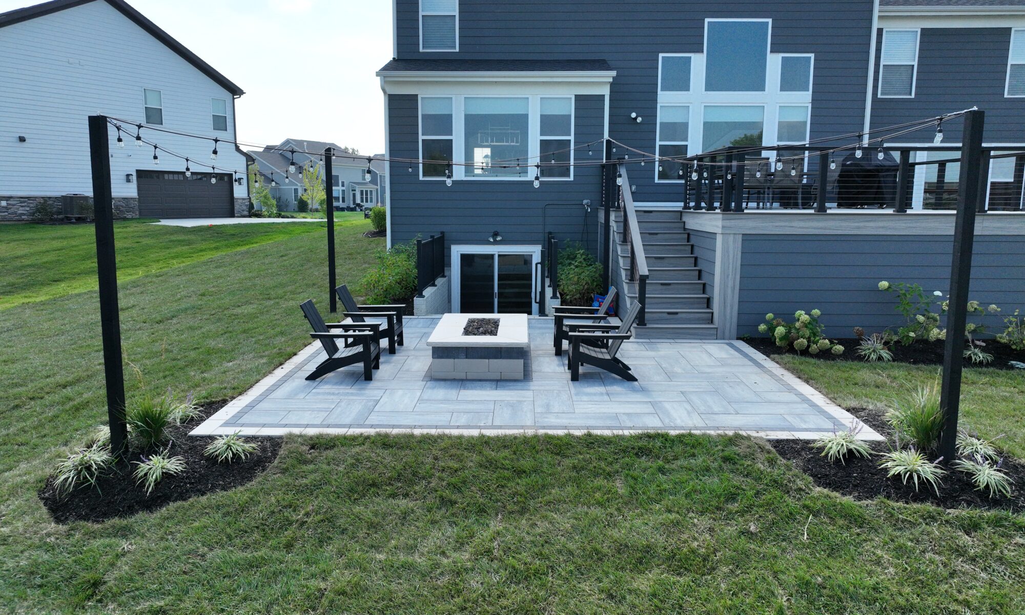 Chatham Elevated Deck Precision Outdoors Deckorators Decking Westfield Indiana Custom Cable railing composition deck string lighting gas firepit fire pit walk out basement custom landscaping paver patio beautiful backyard entertaining space relaxing space