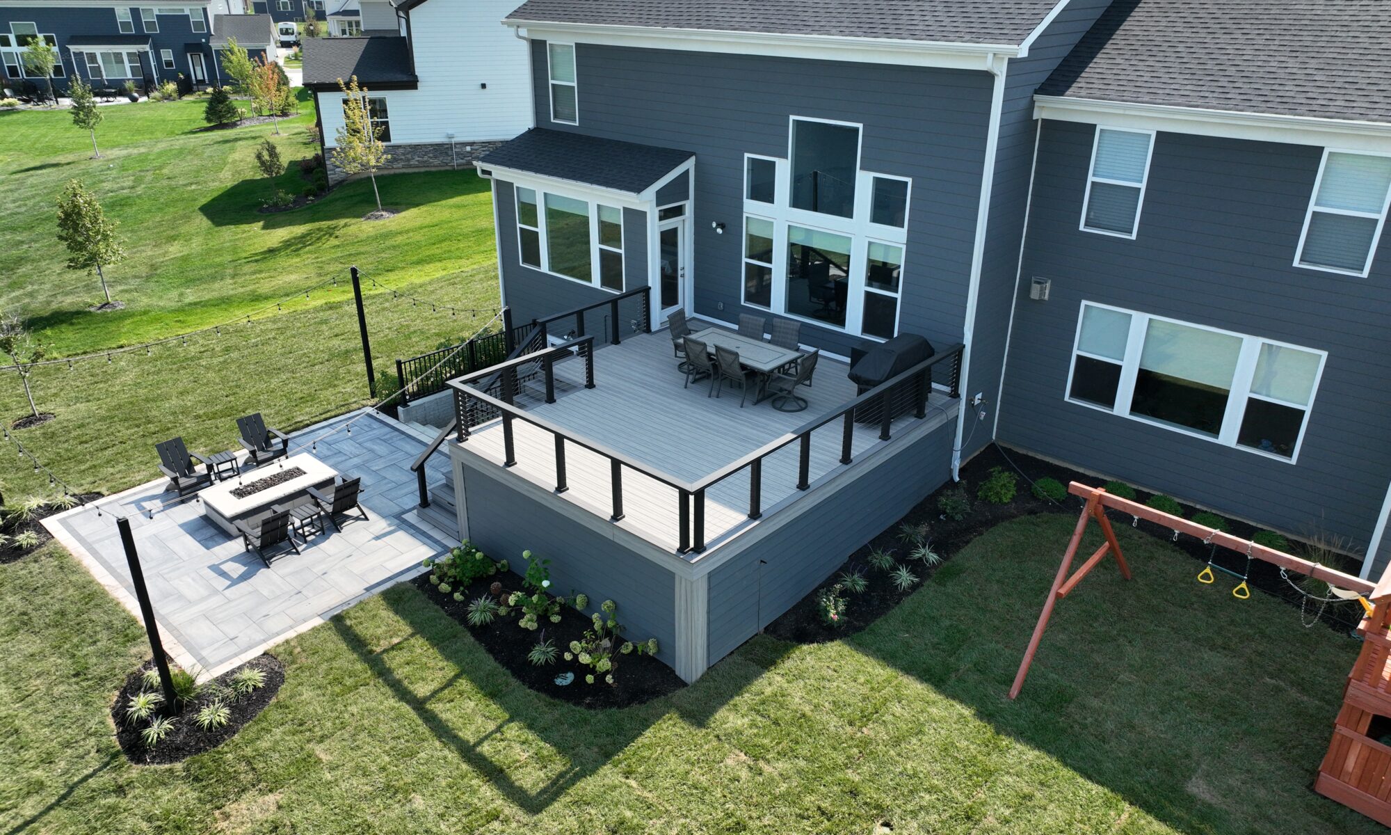 Chatham Elevated Deck Precision Outdoors Deckorators Decking Westfield Indiana Custom Cable railing composition deck string lighting gas firepit fire pit walk out basement custom landscaping paver patio beautiful backyard entertaining space relaxing space